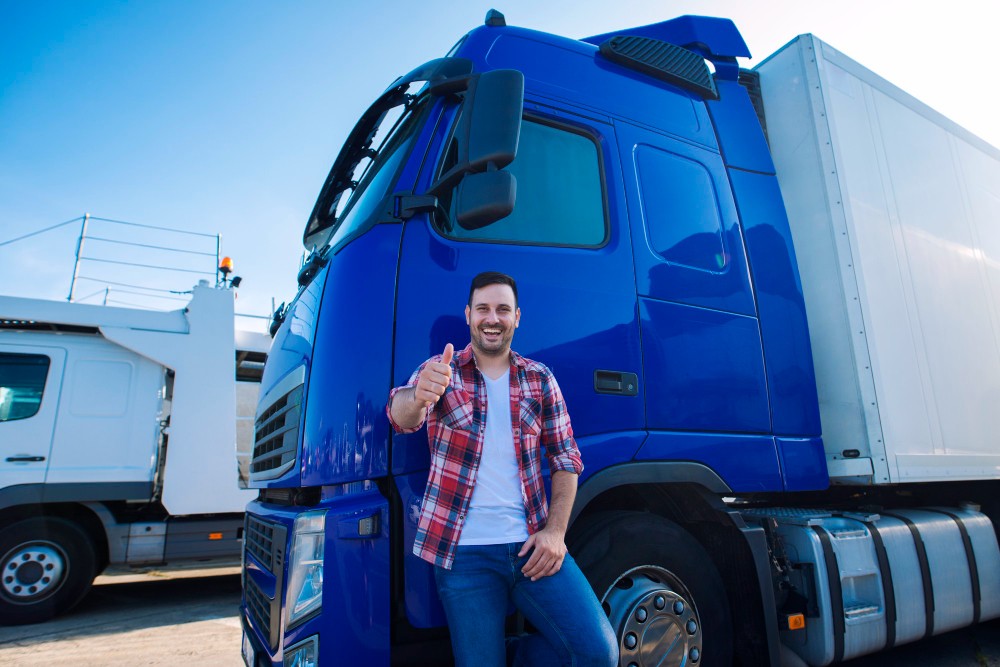professional-truck-driver-front-long-transportation-vehicle-holding-thumbs-up-ready-new-ride (1)